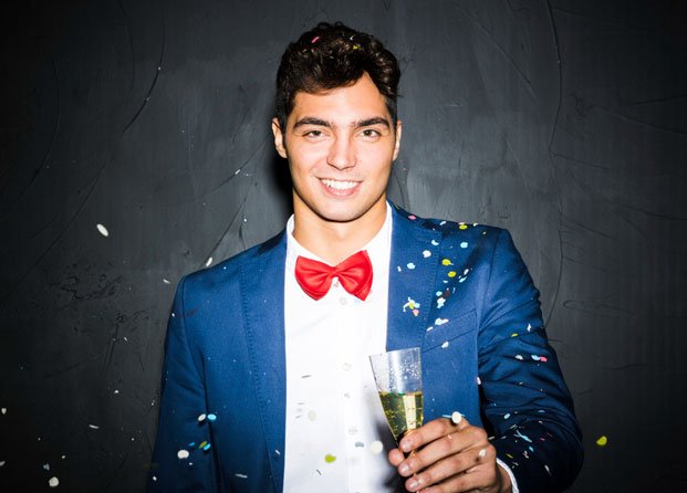 smiling-guy-evening-jacket-with-glass-tossing-confetti